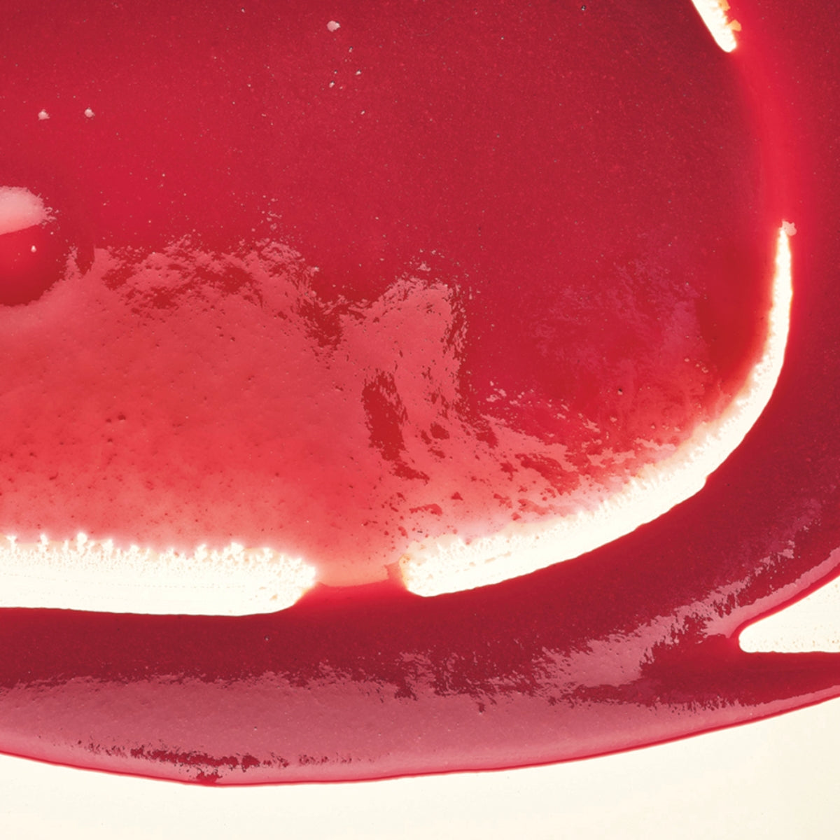 zoom sur la texture d'une purée de fruit à la framboise adamance